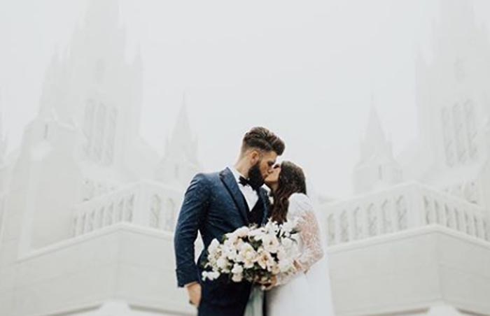 kayla Harper and Bryce Harper kissing on their wedding day.
